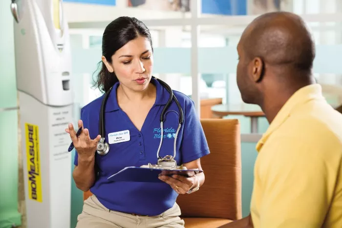 Florida Blue Center nurse discussing chart with customer