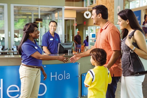 Staff member greeting family at a Florida Blue Center